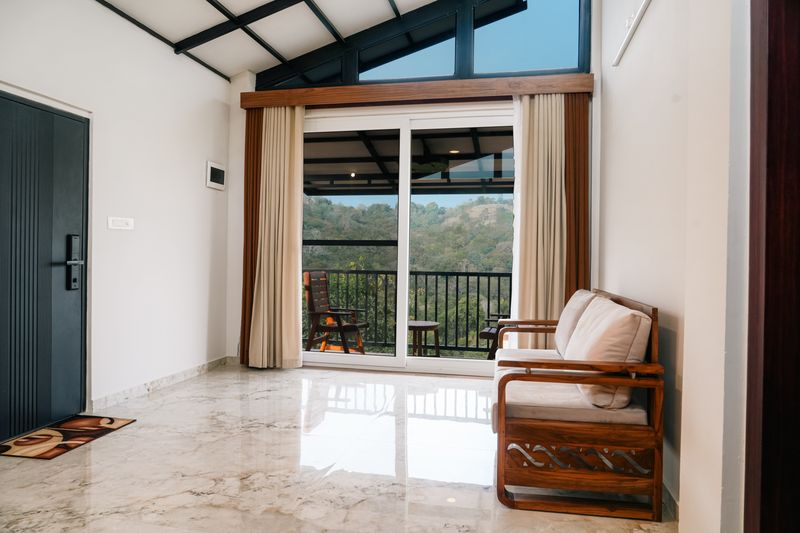 High-ceiling living room with marble floors and mountain view