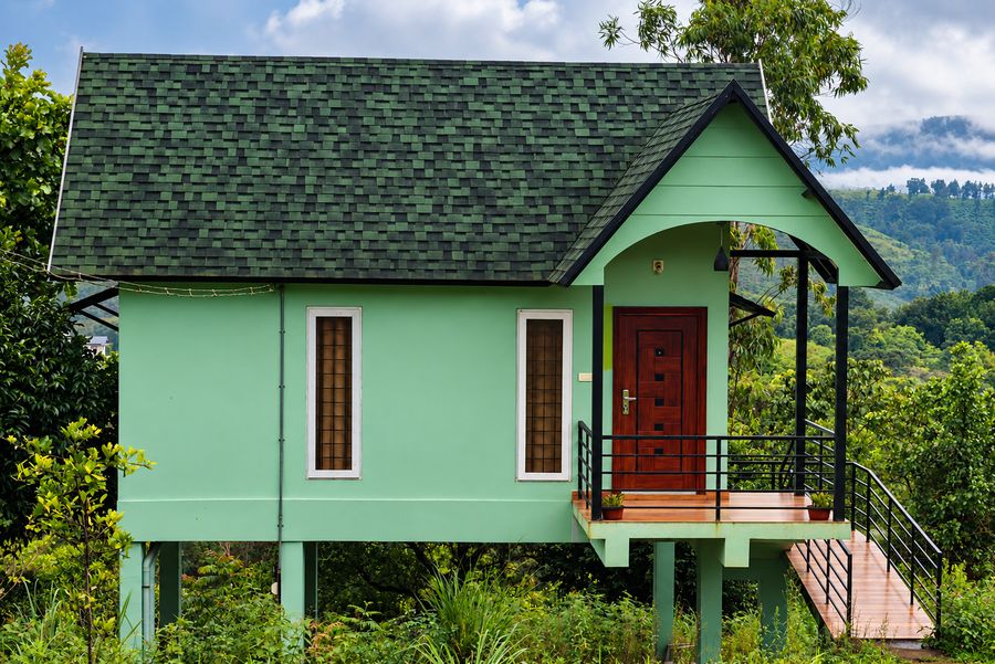 Green cottage overlooking tea estate hills
